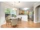 Charming dining area with a view of the kitchen and natural light at 8437 Whisper Ridge Pl, Raleigh, NC 27613