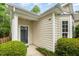 Inviting entryway with a stylish front door and manicured landscaping at 8437 Whisper Ridge Pl, Raleigh, NC 27613