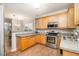 Kitchen featuring stainless steel appliances, and wood cabinets at 8437 Whisper Ridge Pl, Raleigh, NC 27613