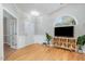Cozy living room featuring an arched window, hardwood floors, and stylish decor at 8437 Whisper Ridge Pl, Raleigh, NC 27613