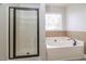 Bathroom with a glass-enclosed shower and a large soaking tub at 95 Lockhaven Ct, Cameron, NC 28326
