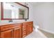 Bathroom featuring double sinks, granite counters, and traditional wood cabinets at 95 Lockhaven Ct, Cameron, NC 28326