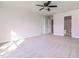 Bright bedroom with plush carpet, ceiling fan, and multiple doors at 95 Lockhaven Ct, Cameron, NC 28326