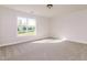Sunlit bedroom with a large window and plush carpet at 95 Lockhaven Ct, Cameron, NC 28326