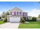 Charming two-story home with a two-car garage, green lawn, and red window shutters at 95 Lockhaven Ct, Cameron, NC 28326