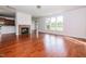 Bright living room features hardwood floors, a tiled fireplace, and large windows overlooking the backyard at 95 Lockhaven Ct, Cameron, NC 28326