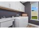 Convenient laundry room with white cabinets, a sink, and a front-loading washer and dryer at 1002 Shovelhead Dr # 58, Durham, NC 27703