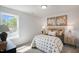 Cozy bedroom with bright window, neutral tones, side tables, and art for a comfortable retreat at 1038 Beacon Hill Rd # 46, Lillington, NC 27546
