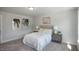 Well-lit bedroom with neutral decor, comfortable bed, and modern bedside tables at 1038 Beacon Hill Rd # 46, Lillington, NC 27546