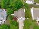 Aerial view of home with well-maintained landscaping, mature trees, and a spacious driveway at 104 Harvolly Dr, Holly Springs, NC 27540