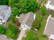 Aerial view of the home showcasing the roof, mature trees, and well-manicured landscaping at 104 Harvolly Dr, Holly Springs, NC 27540