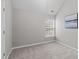 This simple bedroom features a neutral color palette and a window at 104 Harvolly Dr, Holly Springs, NC 27540