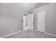 This bedroom features a neutral color palette, multiple doors, and carpet at 104 Harvolly Dr, Holly Springs, NC 27540