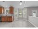 Open kitchen area with tile floors, cozy bay window, and plentiful natural light, perfect for casual dining and entertaining at 104 Harvolly Dr, Holly Springs, NC 27540