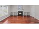 A living room with hardwood floors, featuring a gas fireplace framed by built-in shelves, and soft, natural lighting at 104 Harvolly Dr, Holly Springs, NC 27540