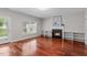 Cozy living room with a gas fireplace, built-in shelving, hardwood floors, and a glass door for access to the outdoors at 104 Harvolly Dr, Holly Springs, NC 27540