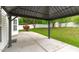 Covered outdoor patio features a concrete flooring and an outdoor entertaining space with lush backyard at 104 Harvolly Dr, Holly Springs, NC 27540