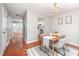 Open-concept dining area with hardwood floors, chandelier, and an adjacent kitchen for easy entertaining at 104 Old Cooper Sq # Bldg J 3, Chapel Hill, NC 27517