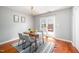 Bright dining room with wood floors, decorative chandelier, and access to the outdoor patio at 104 Old Cooper Sq # Bldg J 3, Chapel Hill, NC 27517