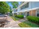 View of the townhome exteriors with brick accents, shutters, and landscaped green space at 104 Old Cooper Sq # Bldg J 3, Chapel Hill, NC 27517