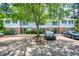 Townhouse complex featuring neutral siding, brick accents, shutters, and an asphalt parking lot at 104 Old Cooper Sq # Bldg J 3, Chapel Hill, NC 27517