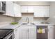 Updated kitchen features white cabinetry, stainless steel appliances, and a bright design at 104 Old Cooper Sq # Bldg J 3, Chapel Hill, NC 27517