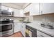 Updated kitchen features white cabinetry, stainless steel appliances, and marble countertops at 104 Old Cooper Sq # Bldg J 3, Chapel Hill, NC 27517