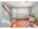 Cozy living room with a staircase, hardwood floors, and natural light at 104 Old Cooper Sq # Bldg J 3, Chapel Hill, NC 27517