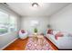 Bright living room features hardwood floors, large window, and comfortable seating area at 104 Old Cooper Sq # Bldg J 3, Chapel Hill, NC 27517