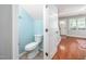 Bright powder room with modern toilet adjacent to the main entry hallway of the home at 104 Old Cooper Sq # Bldg J 3, Chapel Hill, NC 27517