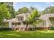 Exterior showcasing a pristine yard with a screened-in porch, deck, patio and green lawn at 104 Planetree Ln, Cary, NC 27511