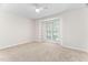 Bright bedroom features a window, built-in shelving and a ceiling fan at 104 Planetree Ln, Cary, NC 27511