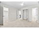 Spacious bedroom with neutral carpet and three doors showcasing open layout at 104 Planetree Ln, Cary, NC 27511