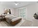 Bright bedroom features a bed, built-in shelving, and a large window at 104 Planetree Ln, Cary, NC 27511
