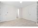 Spacious bedroom with neutral carpet, white walls, and ample natural light at 104 Planetree Ln, Cary, NC 27511