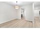 Dining room with wood-look flooring and view into the kitchen at 104 Planetree Ln, Cary, NC 27511