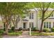 Charming white two-story home with lush landscaping and inviting front entrance at 104 Planetree Ln, Cary, NC 27511