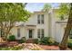 Inviting two-story white house with well-manicured landscaping and traditional details at 104 Planetree Ln, Cary, NC 27511