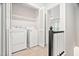 Bright laundry room boasts side by side washer and dryer units and additional shelving at 104 Planetree Ln, Cary, NC 27511