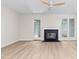 Bright living room featuring a fireplace and glass door leading to backyard at 104 Planetree Ln, Cary, NC 27511