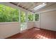 Relaxing screened porch with wood floors, fan and wooded views provides a comfortable retreat at 104 Planetree Ln, Cary, NC 27511