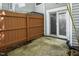 Enclosed back patio with sliding glass door entry and a wooden privacy fence at 104 Sir Richard Ln, Chapel Hill, NC 27517