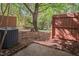 Fenced backyard featuring a private patio and lush green trees at 104 Sir Richard Ln, Chapel Hill, NC 27517