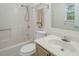Well-lit bathroom showcasing a shower-tub combination, toilet, and a vanity with a sink at 104 Sir Richard Ln, Chapel Hill, NC 27517