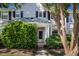 Inviting townhome facade with a covered porch, fresh landscaping, and a well-maintained exterior at 104 Sir Richard Ln, Chapel Hill, NC 27517