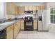 Bright kitchen with modern stainless steel refrigerator and black appliances at 104 Sir Richard Ln, Chapel Hill, NC 27517