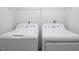 Laundry room featuring a white washer and dryer, with storage shelf above at 104 Sir Richard Ln, Chapel Hill, NC 27517