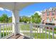 Scenic view from the covered balcony overlooking a well-manicured lawn and neighboring homes at 10530 Sablewood Dr # 112, Raleigh, NC 27617