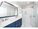 Modern bathroom with double vanity, framed mirror, and glass shower at 10530 Sablewood Dr # 112, Raleigh, NC 27617