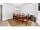 Spacious dining room with a classic chandelier and an ornate wood table and chairs at 10530 Sablewood Dr # 112, Raleigh, NC 27617